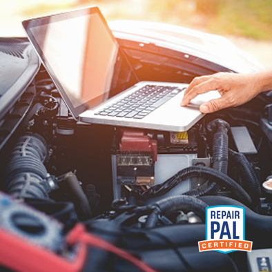 laptop on car engine. repairpal certified. 
